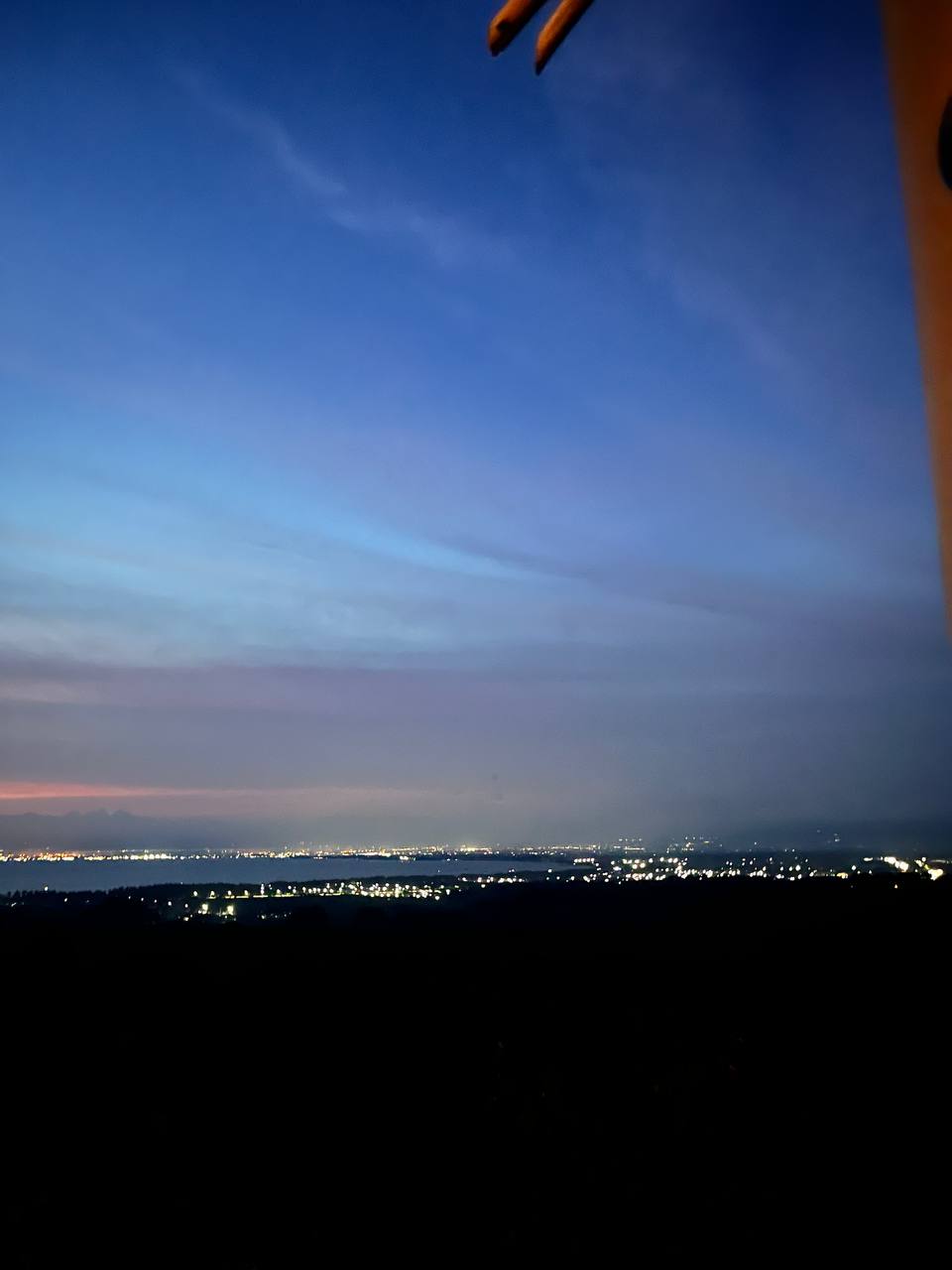 City lights along the bay at dusk, seen from the hilltop