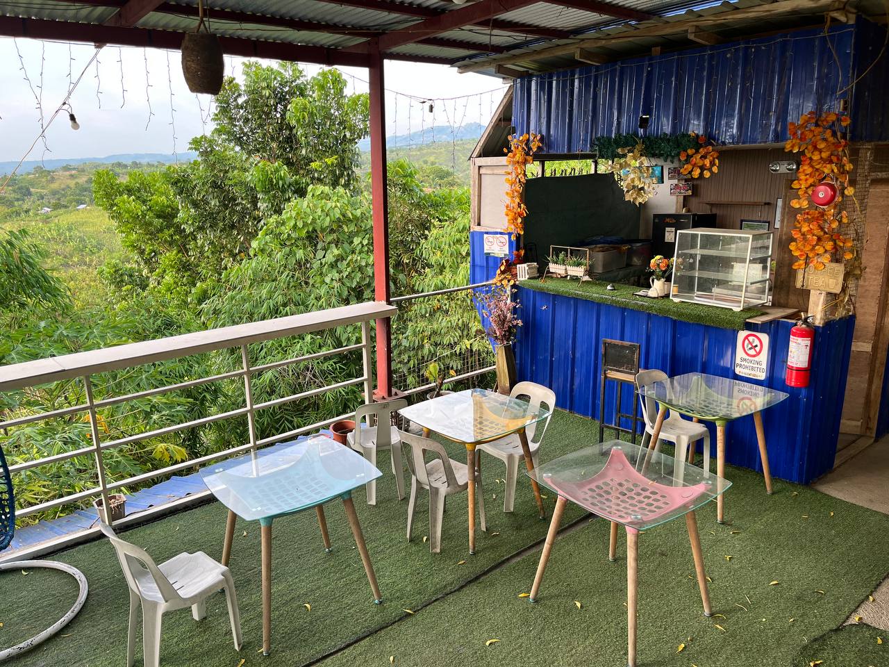 Coffee bar and glass tables beside the treetops