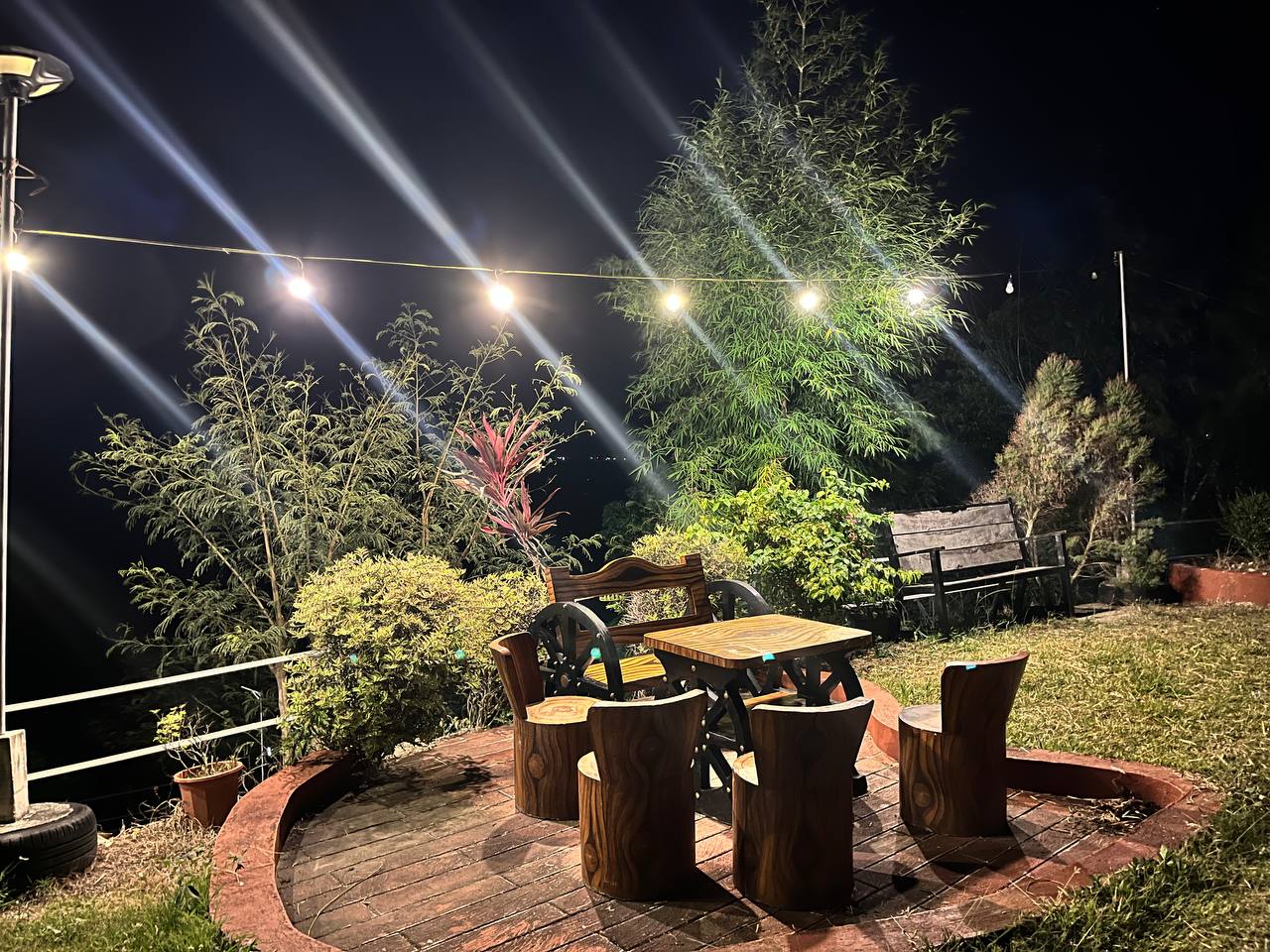 Garden table under string lights at night